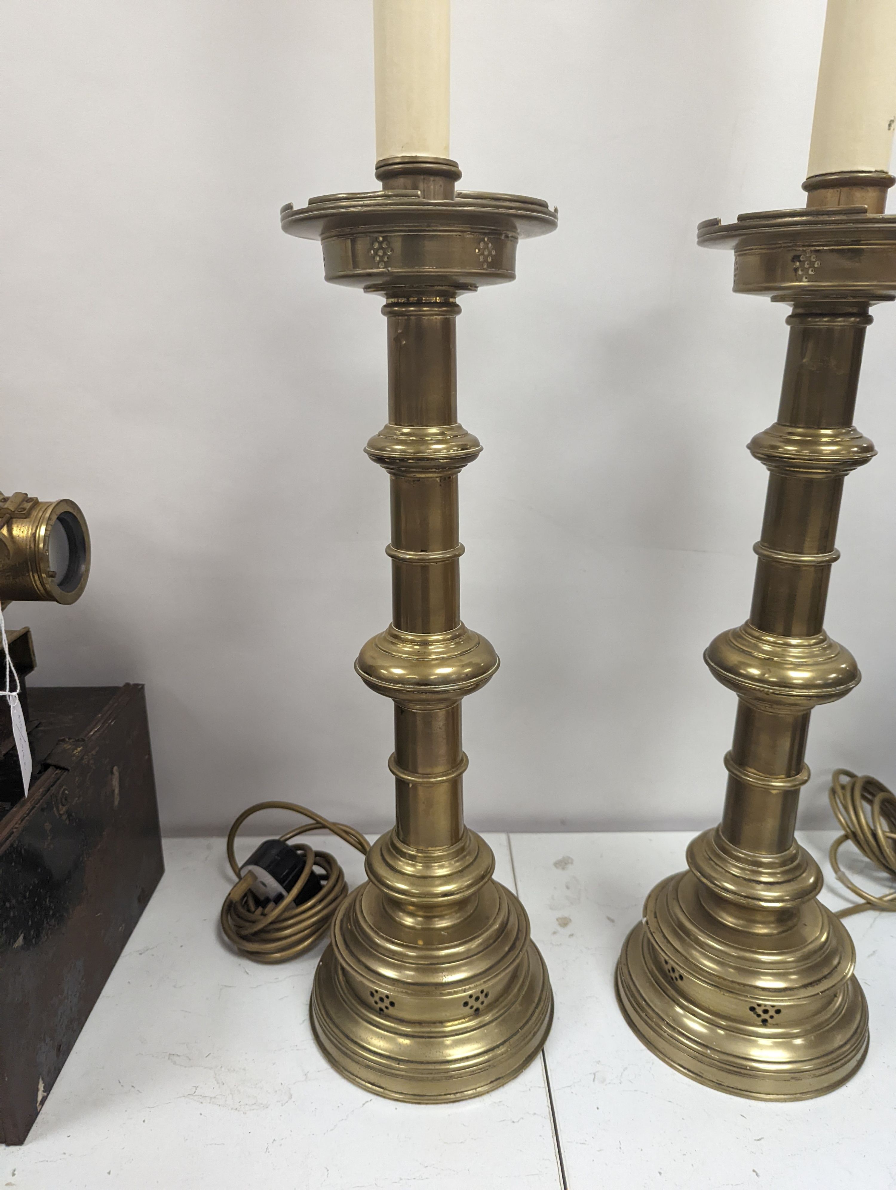 A pair of Gothic style brass table lamps, height 79cm